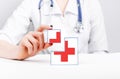 First aid. Cubes with red cross in doctor hands. Urgent medical care, immediate assistance to patient. Woman in lab coat Royalty Free Stock Photo