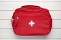 First aid kit bag on white wooden background, top view Royalty Free Stock Photo