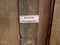 First aid kit fire extinguisher sign on wood door Royalty Free Stock Photo