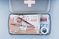 First aid kit packed with medical supplies on grey background Royalty Free Stock Photo