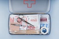 First aid kit packed with medical supplies on grey background Royalty Free Stock Photo