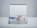 First aid kit packed with medical supplies on grey background Royalty Free Stock Photo