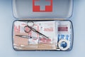 First aid kit packed with medical supplies on grey background Royalty Free Stock Photo