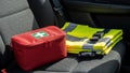 First aid kit and safety vest on car seat highlight preparedness and safety Royalty Free Stock Photo