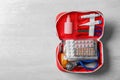 First aid kit on white wooden background, top view Royalty Free Stock Photo