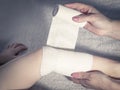 First aid at knee trauma. Royalty Free Stock Photo