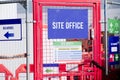 First aid site office sign on construction building site door entrance fence