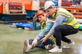 First aid support accident at work of worker at factory. Male worker has an accident  on the floor in factory site Royalty Free Stock Photo