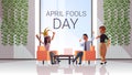 First april fool day mix race businesspeople wearing funny jester hat glasses mustache holiday celebration concept Royalty Free Stock Photo