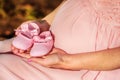 First baby girl shoes in a parent hands Royalty Free Stock Photo