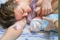 The first breast feeding of a newborn baby boy immediately after giving birth on a hospital bed in a maternity ward Royalty Free Stock Photo