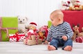 First Christmas: baby unwrapping a present - happy family - children eyes Royalty Free Stock Photo