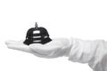 First-class service. Hand in white gloves holding hotel bell Royalty Free Stock Photo