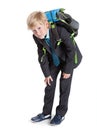 First class student holding heavy schoolbag on the back, full length, isolated white background