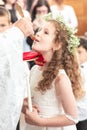 First communion. Portrait of cute little girl on white dress and wreath on first holy communion Royalty Free Stock Photo