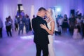 First dance of stylish wedding couple. Handsome groom and elegant bride in the restaurant Royalty Free Stock Photo