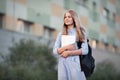 The first day back to school. high school girl portrait of teen model with long blonde hair with backpack, textbooks and notebooks