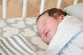 First day of the child at home. Newborn baby sleep first days of life. Cute little newborn child sleeping peacefully Royalty Free Stock Photo