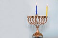 First day of Hanukkah with burning Hanukkah colorful candles in Menorah traditional Candelabra