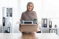 Happy Muslim Female Employee Holding Box With Her Belongings In Office
