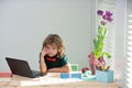 First day at school. Cute little children using laptop computer, studying through online e-learning. Royalty Free Stock Photo