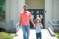 First day at school. Father leads a little child school girl in first grade. School boy going to school with father. Royalty Free Stock Photo