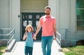 First day at school. Father leads a little child school girl in first grade. School boy going to school with father. Royalty Free Stock Photo