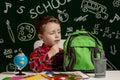 First day of school. Kid boy from primary school. Back to school. Little boy collects school backpack to school. Child from