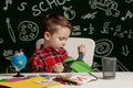 First day of school. Kid boy from primary school. Back to school. Little boy collects school backpack to school. Child from