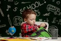 First day of school. Kid boy from primary school. Back to school. Little boy collects school backpack to school. Child from