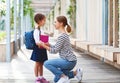 First day at school. mother leads little child school girl in f