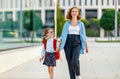 First day at school. mother leads little child girl in grade