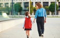 First day at school. mother leads little child girl in grade