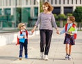 First day at school. mother leads little children girl and boy in grade