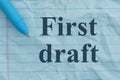 First draft concept on blue crumbled lined loose leaf notebook paper with pen Royalty Free Stock Photo