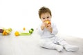 First food of the child. baby surrounded with fruits and vegetables, healthy child nutrition