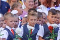 First-form schoolchildren at school on holiday of beginning of elementary education. Boys at school holiday ceremony holding