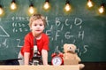 First former interested in studying, learning, education. Primary school concept. Kid boy near microscope in classroom