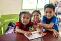 First grade schoolchildren helping each other, Elementary School, Camiguin Island, Republic of the Philippines Royalty Free Stock Photo