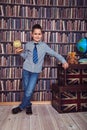 First-grader boy with a board in a library Royalty Free Stock Photo