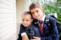 First-grader boy hugs his younger brother