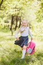 First-grader girl with a school backpack outdoors Royalty Free Stock Photo