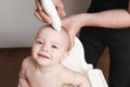 First haircut of smiling toddler baby.