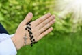 First Holy Communion with rosary around praying boy hands