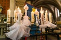 First holy communion or confirmation burning candles rowed up in church before ceremony beautiful decoration