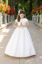 First Holy Communion, innocence girl praying in the park dressed in communion dress. Hands together, as if praying Royalty Free Stock Photo