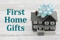 First Home Gift with a house with a bow on a desk Royalty Free Stock Photo