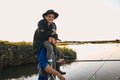 The first joint fishing of adult father and teen son in warm, sunny day. Royalty Free Stock Photo
