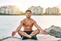 But first, let me get some calm. a handsome young man meditating outdoors.