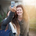 But first, let me take a selfie. two young women taking a selfie outdoors. Royalty Free Stock Photo